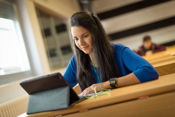 Young female student at university classroom.